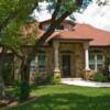 Level front yard, cut-stone columns